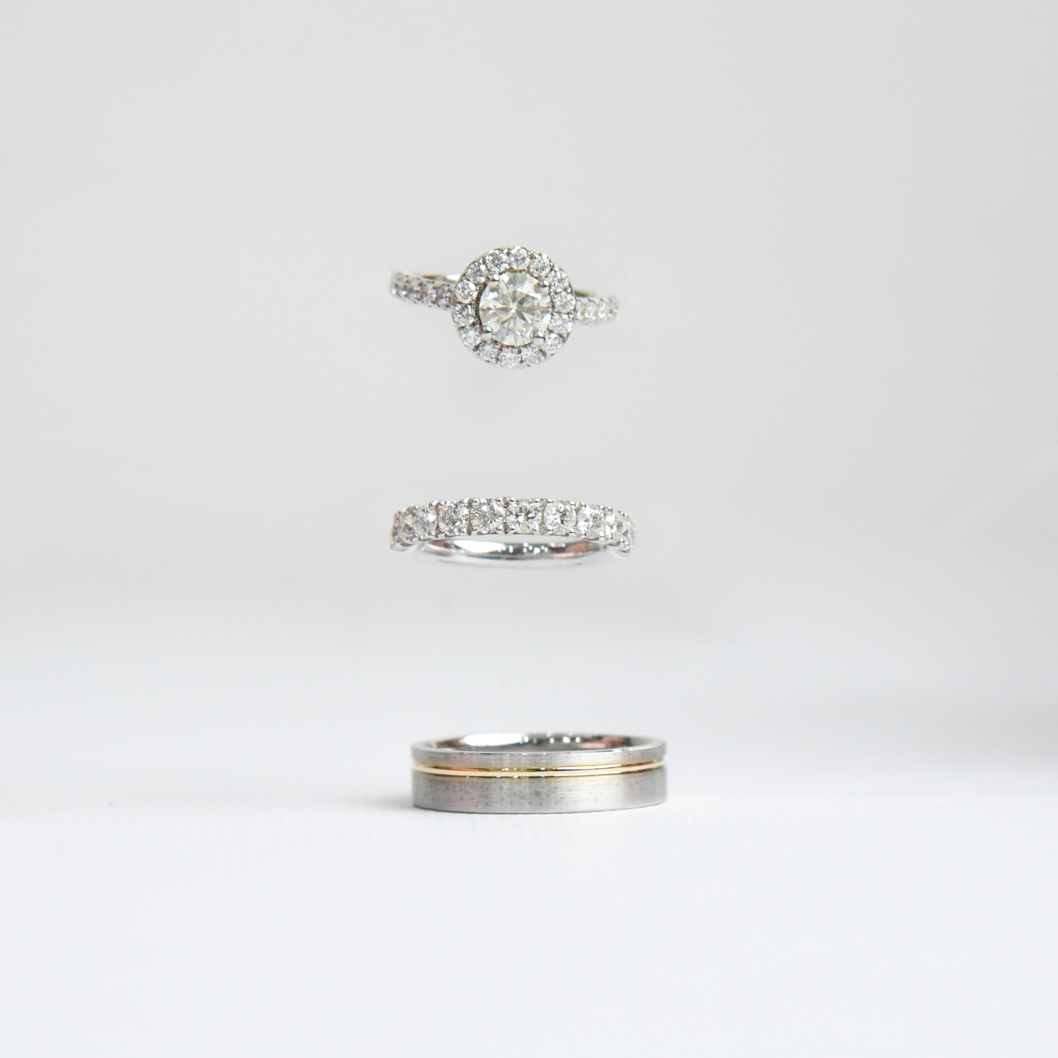 engagement and wedding rings in suspension