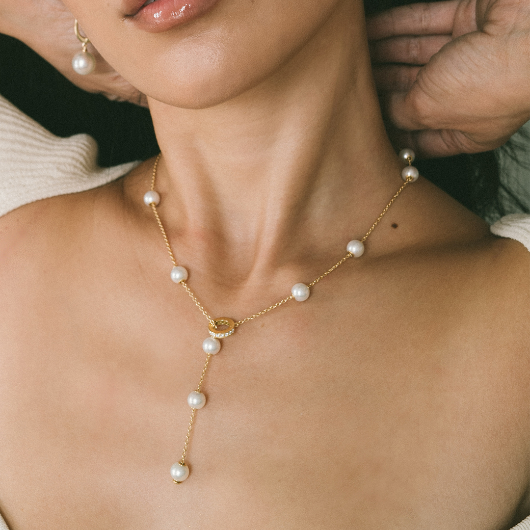 Mikimoto model wearing pearl necklace on skin