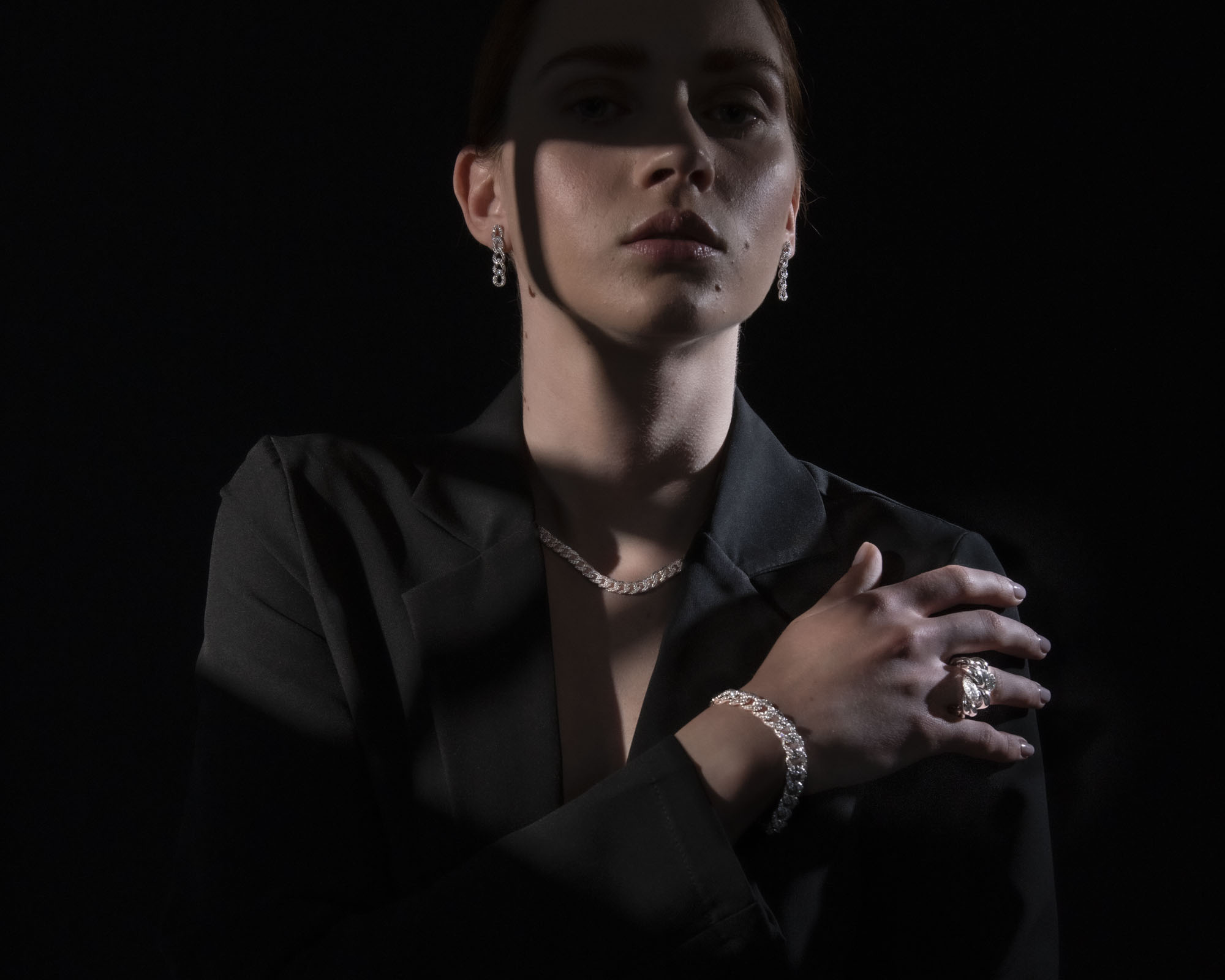 Piero Milano model wearing diamond earrings, necklace, and bracelet