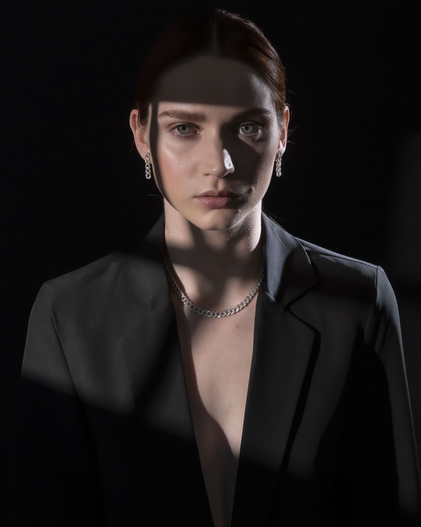 Piero Milano model wearing diamond earrings, and necklace